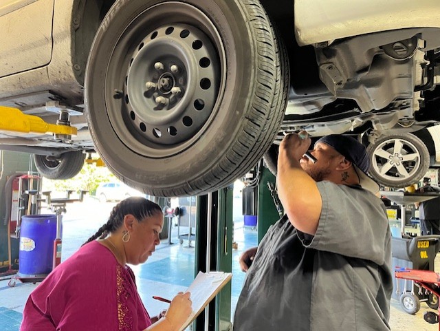 Mando and Amber under a car fixing it
