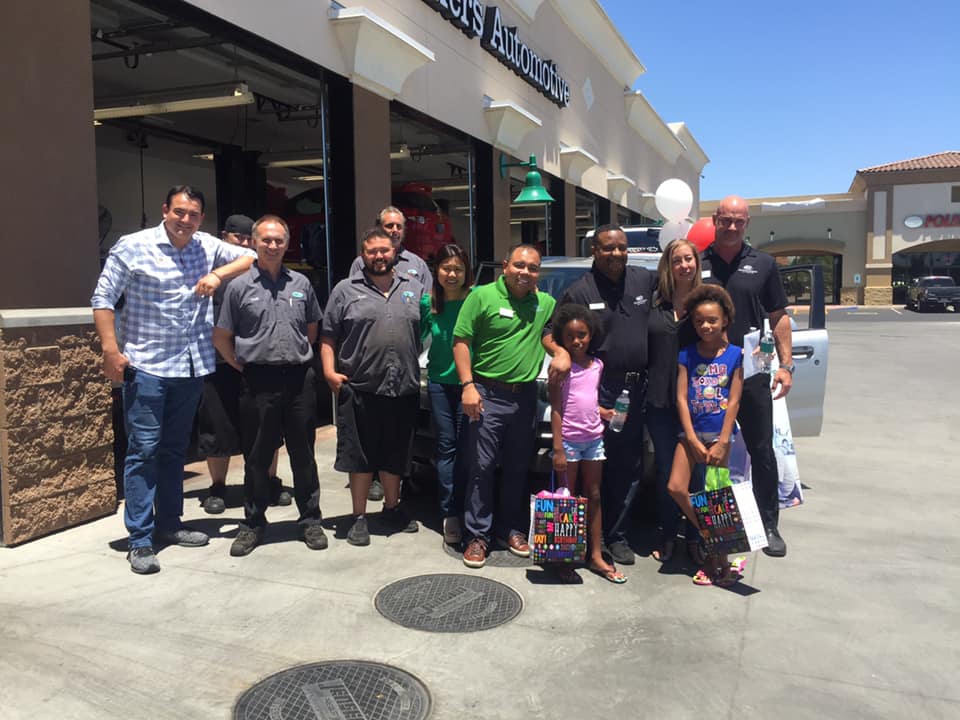 people in front of christian brothers automotive