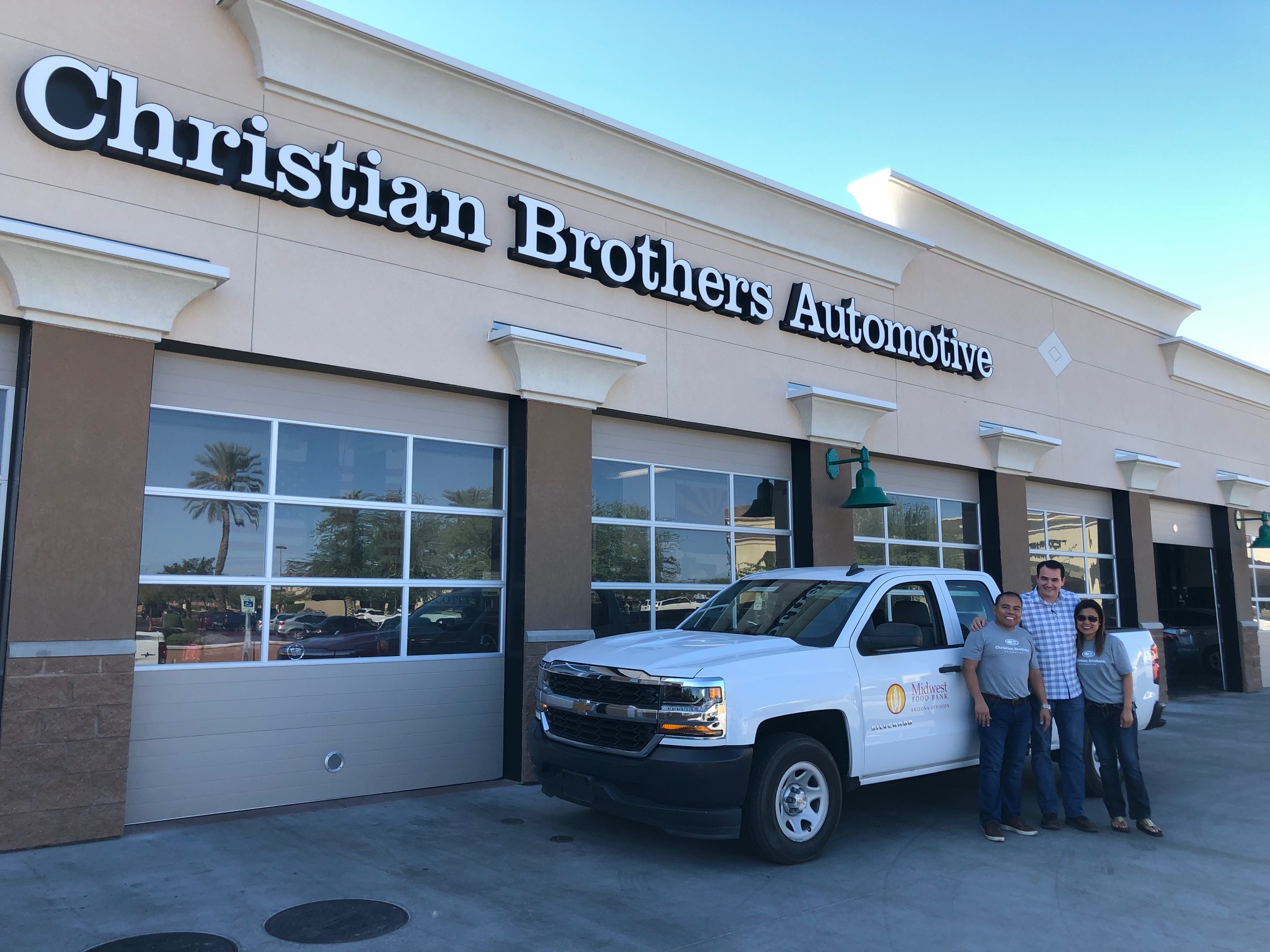 Truck and team in front of Christian Brothers Automotive 