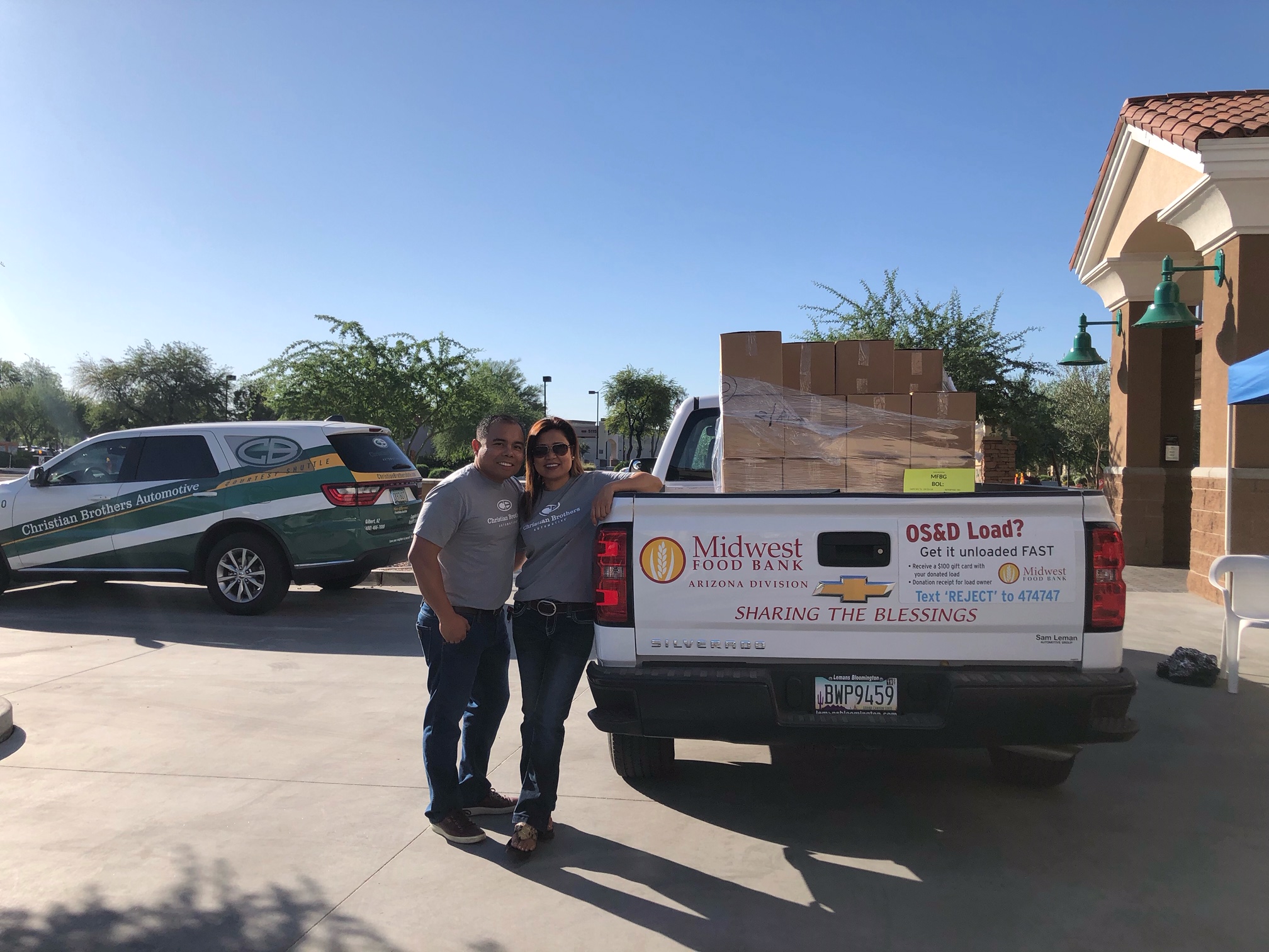 people leaning on pickup truck