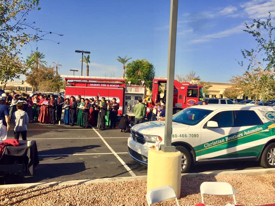 people in parking lot in front of firetruck