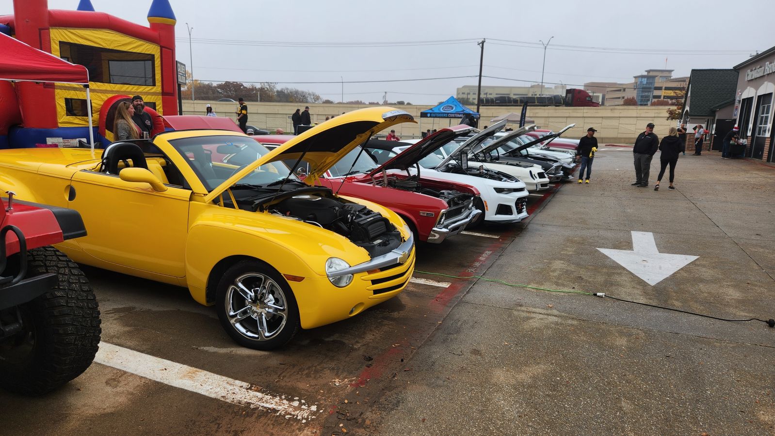 cars in a line with their hoods popped